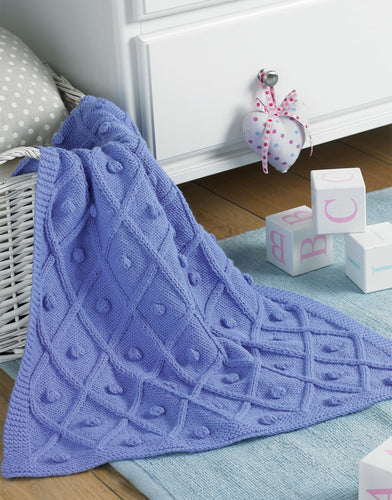 Sirdar knitting pattern 5236 A lattice and bobble pattern baby blanket knitted in Aran yarn.